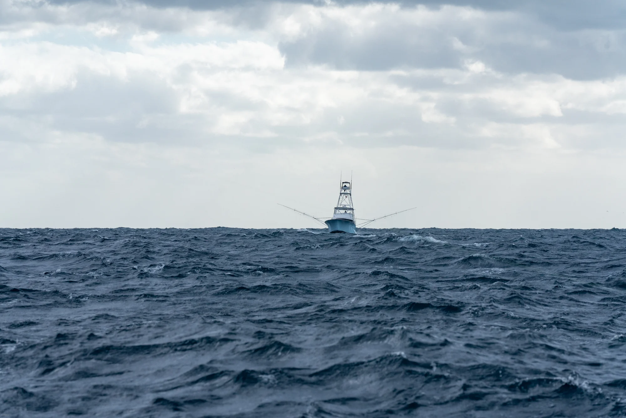 Sportfishing boat on horizon in Atlantic Ocean